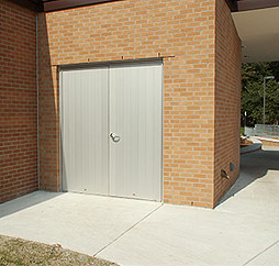 installed aluminum plank door with flush pair on storage room